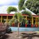 A pavilion in a lush, tropical landscape